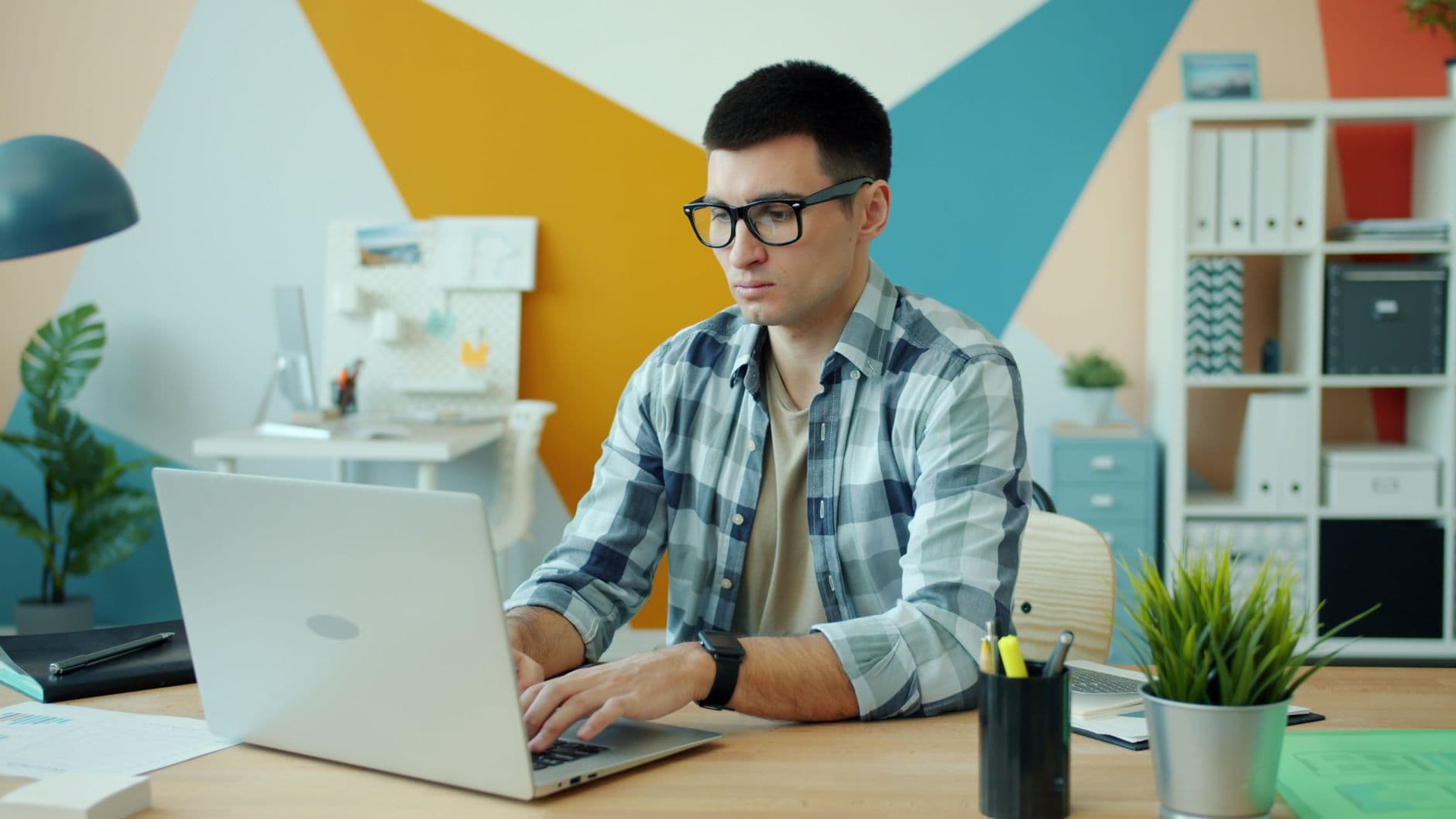 A man checking his email inbox on a laptop