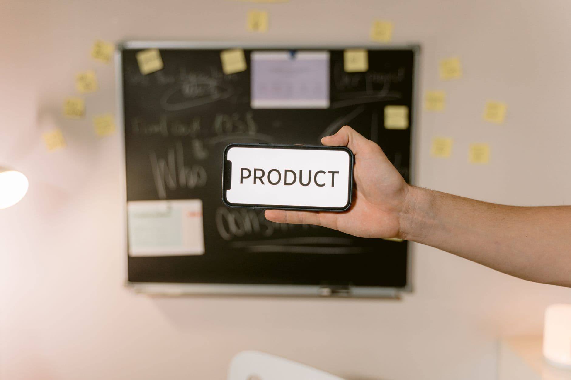 A hand photographing a product label with a smartphone