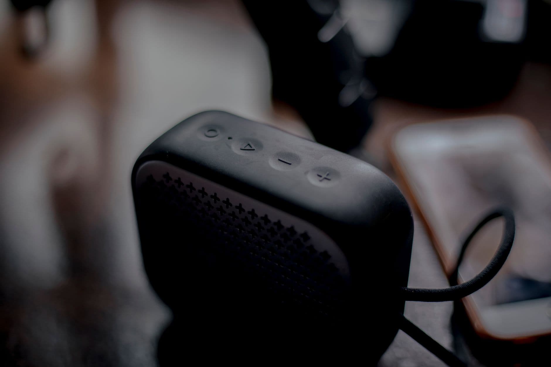 A close view of a smartphone speaker with a sound wave graphic