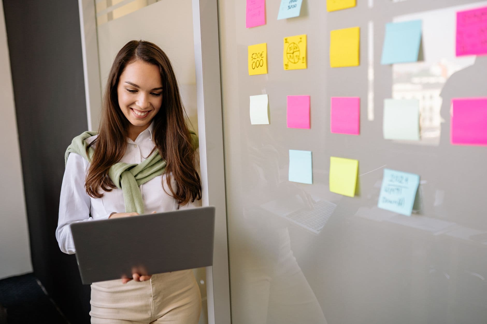 Handwritten labels on sticky notes stuck to a glass wall