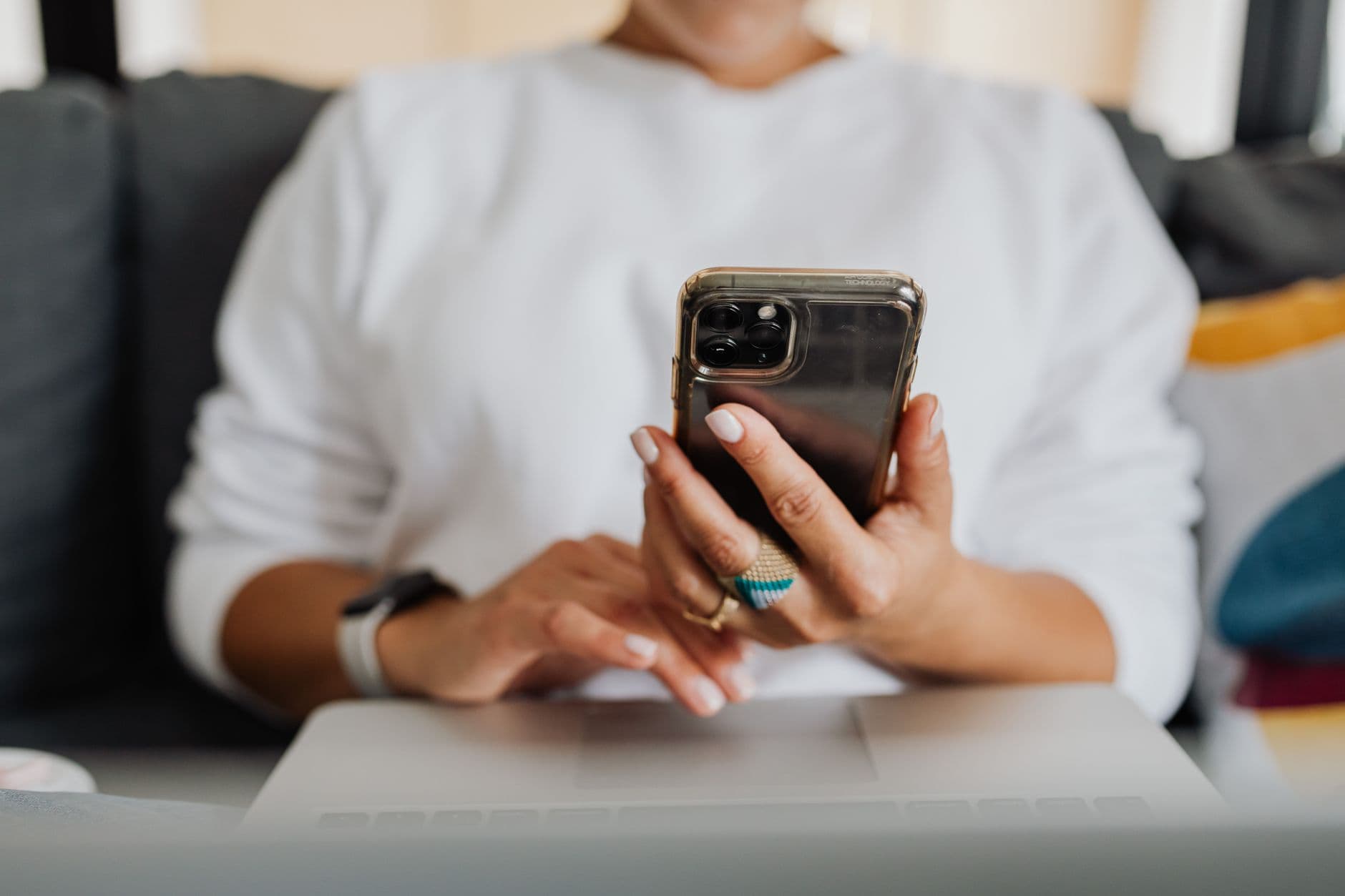 A phone ringing on a desk next to an open laptop