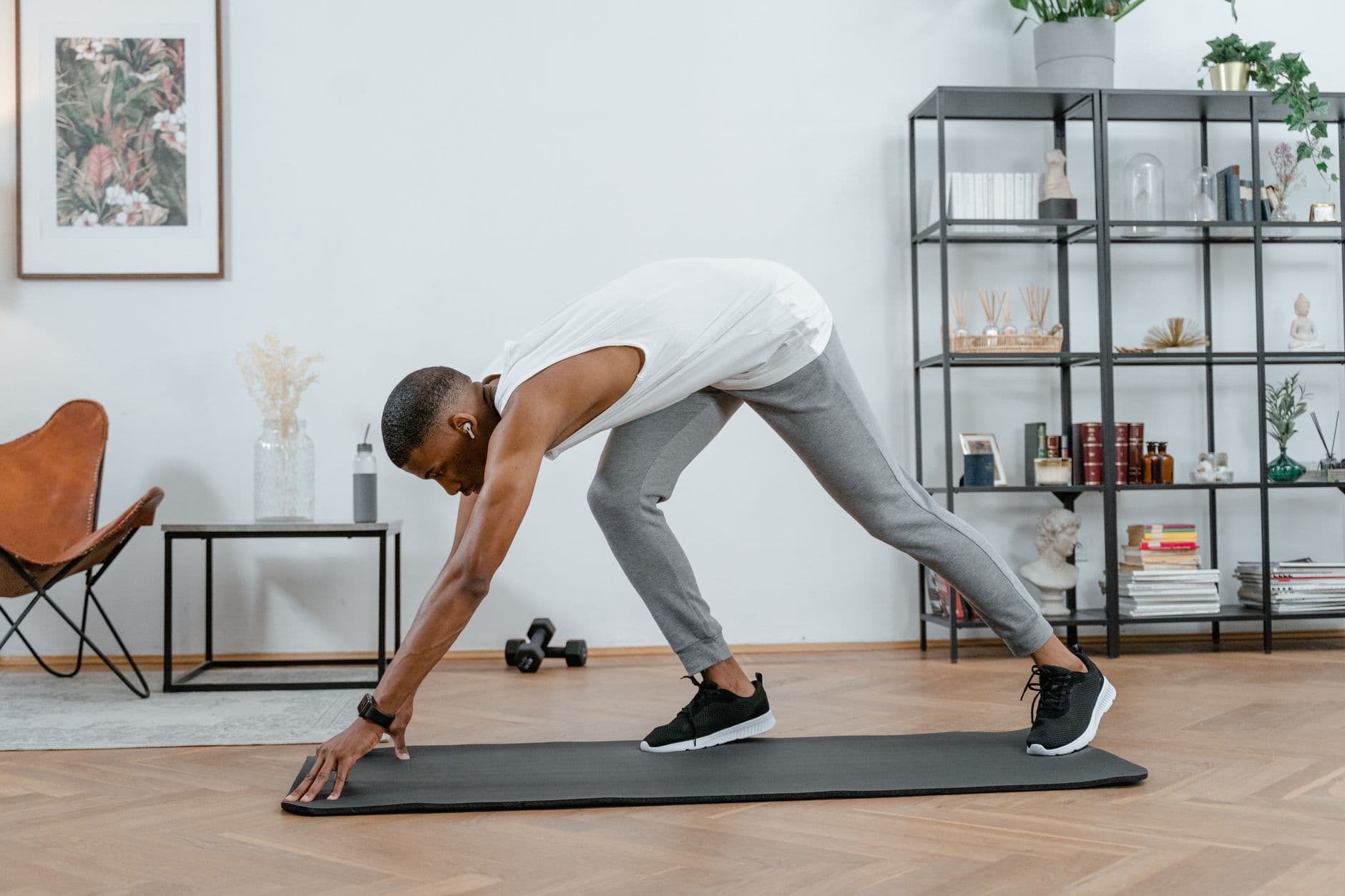 A woman stretching on an exercise mat at home