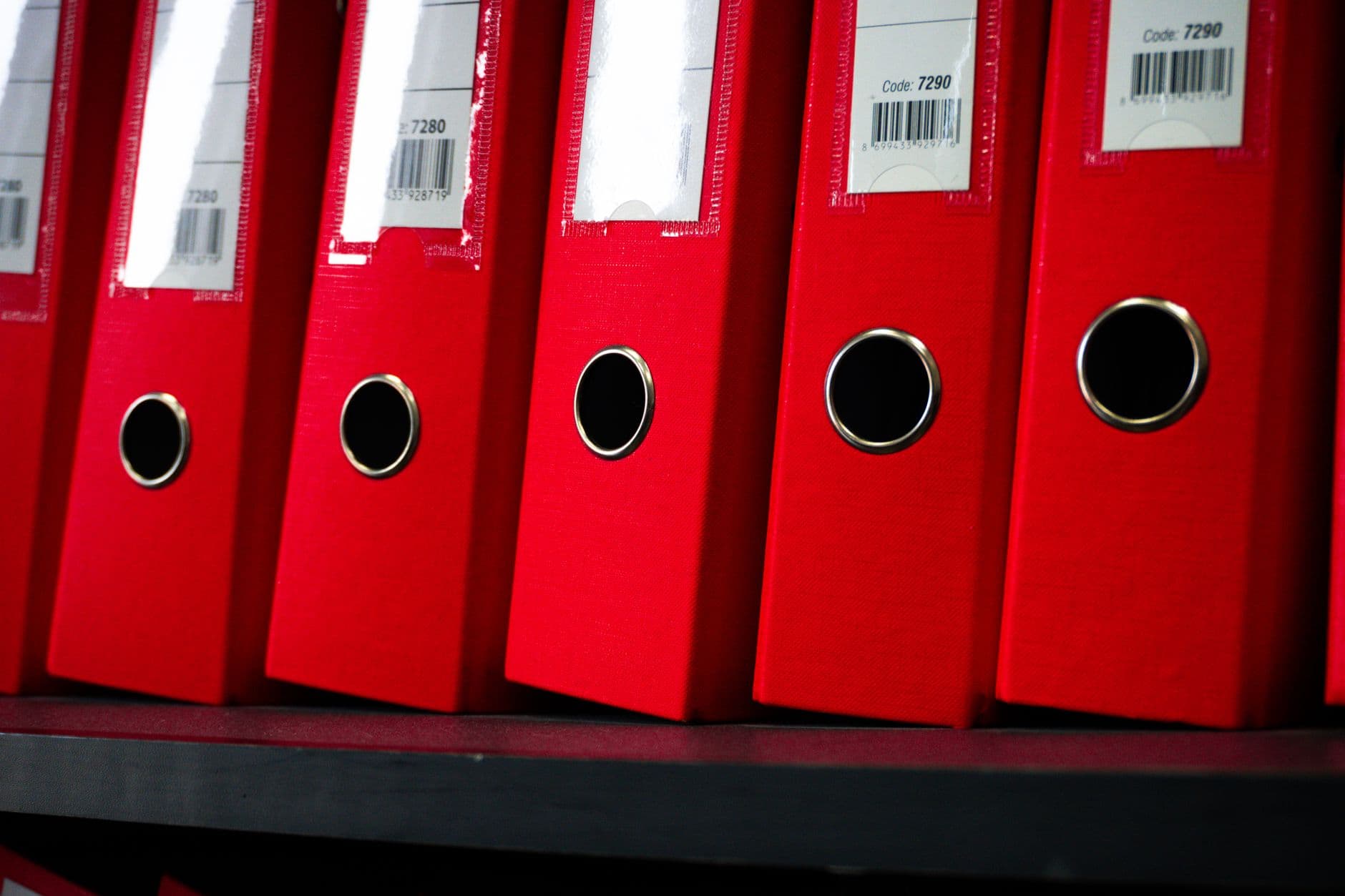 Bound legal case files stacked on an office shelf