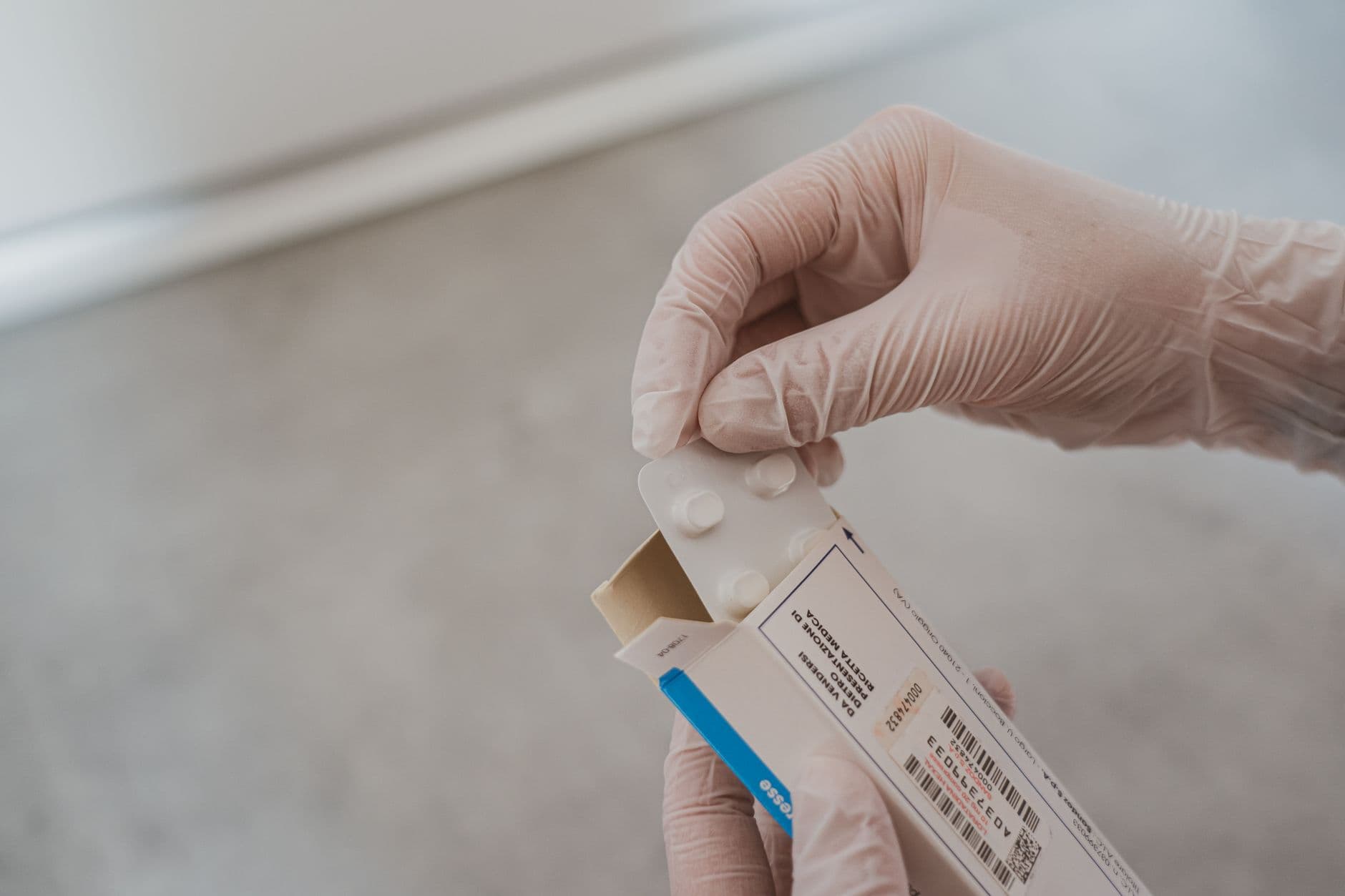 A pair of hands holding a blister pack of tablets