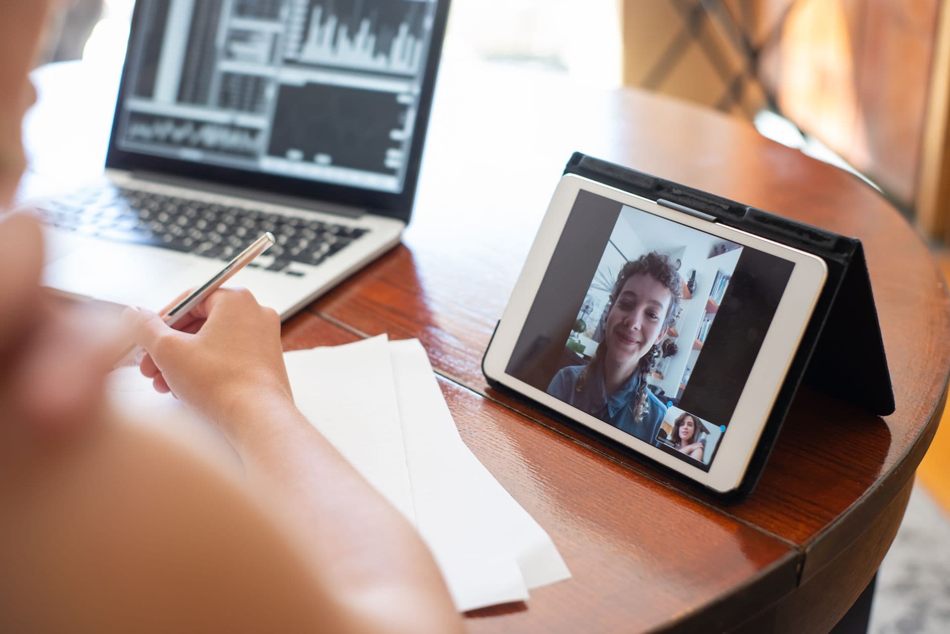A woman on a video call at her home-office laptop