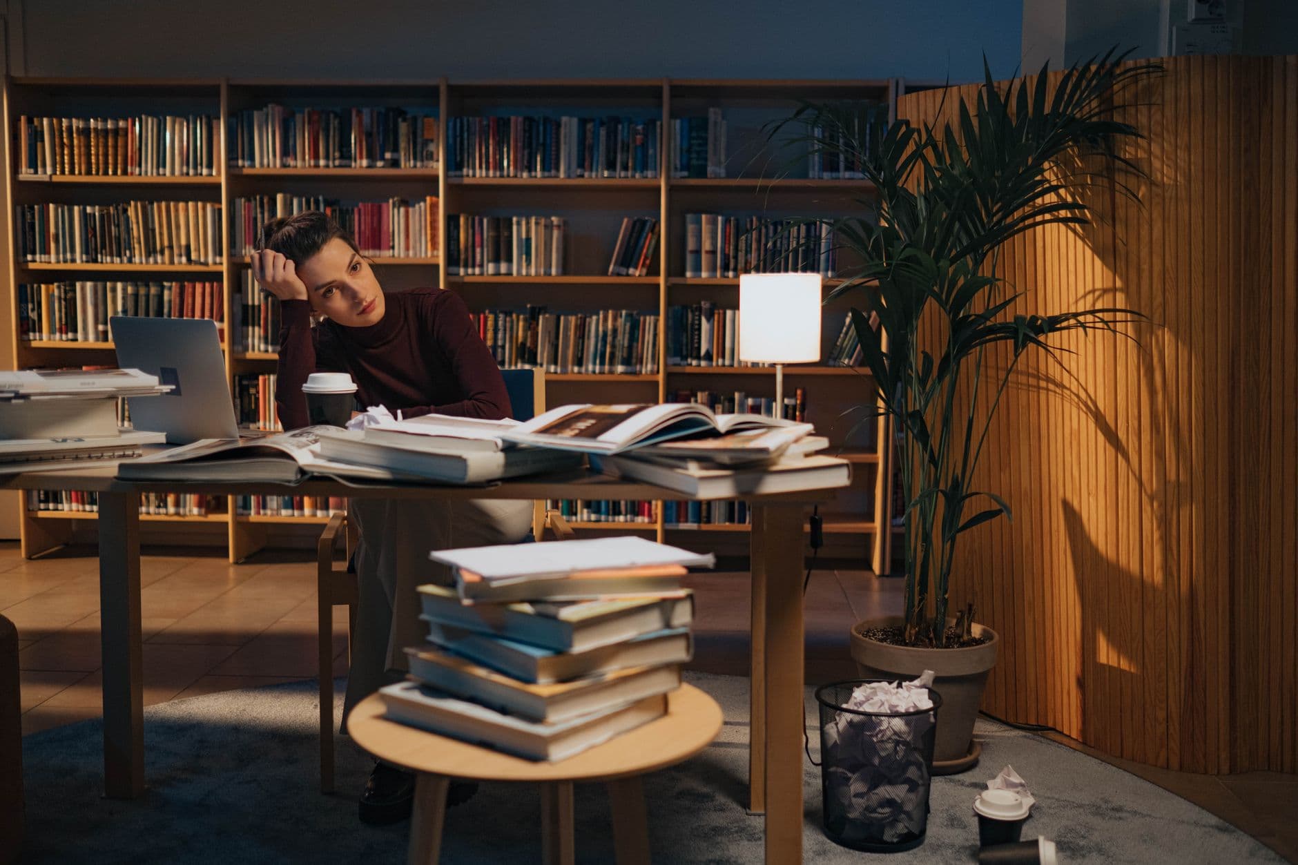 A student working at a laptop in a library