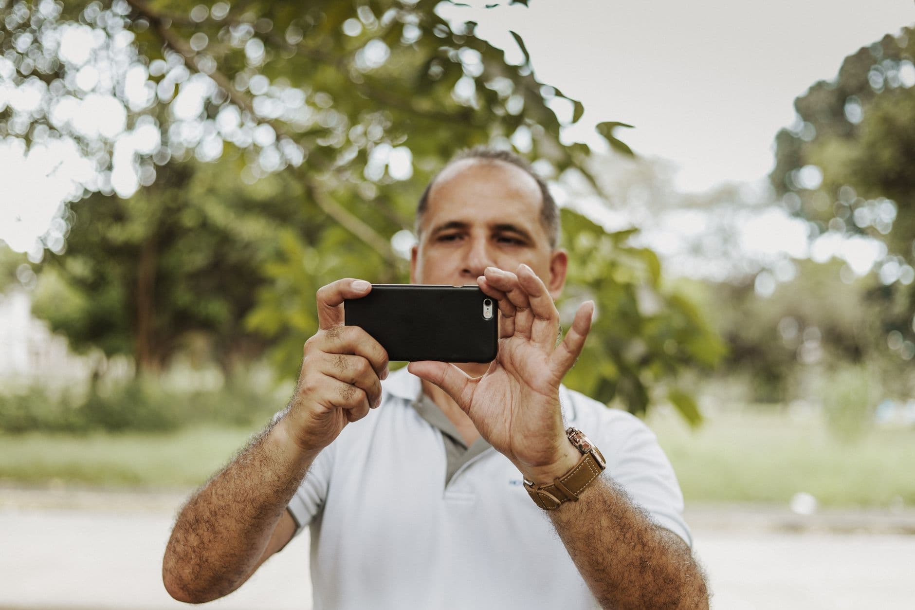 A builder photographing pipework with a smartphone