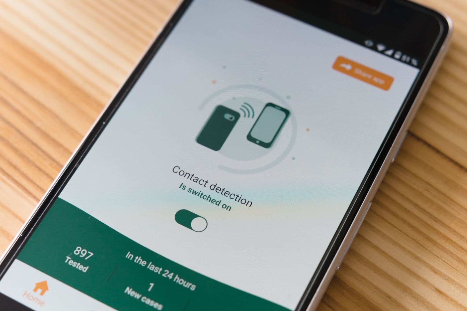 A hand tapping a smartphone notification settings screen
