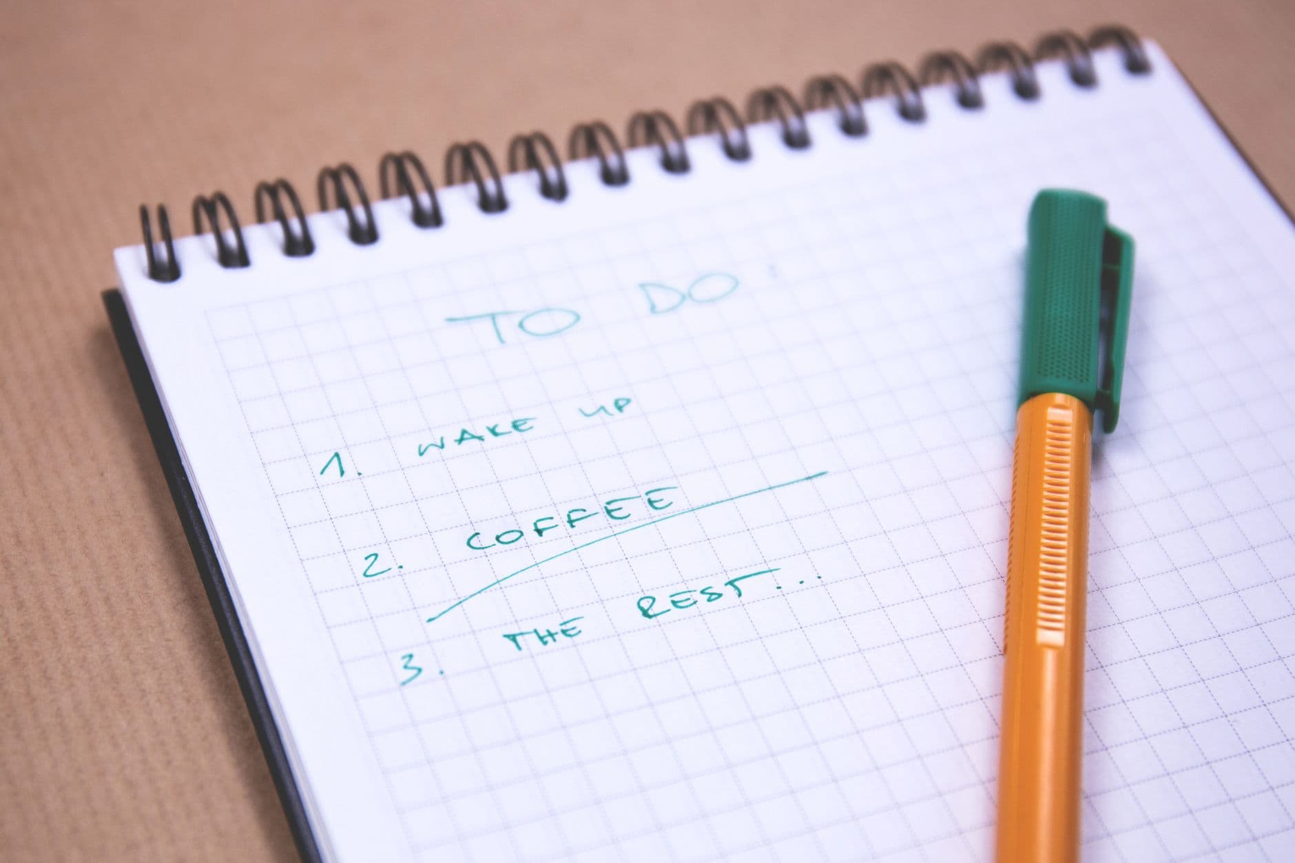 A pen writing notes in an open notebook