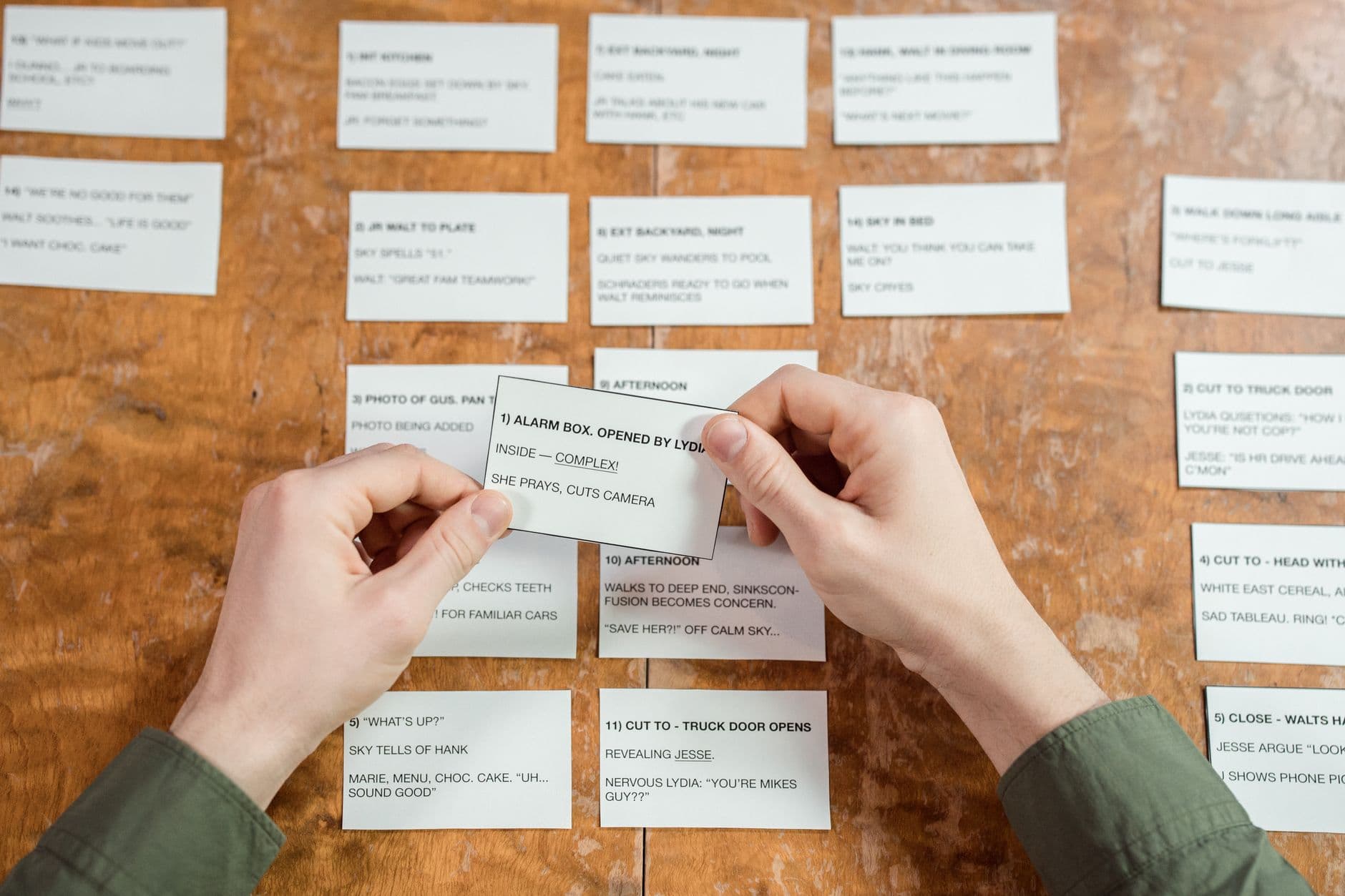Someone sorting handwritten task cards on a desk