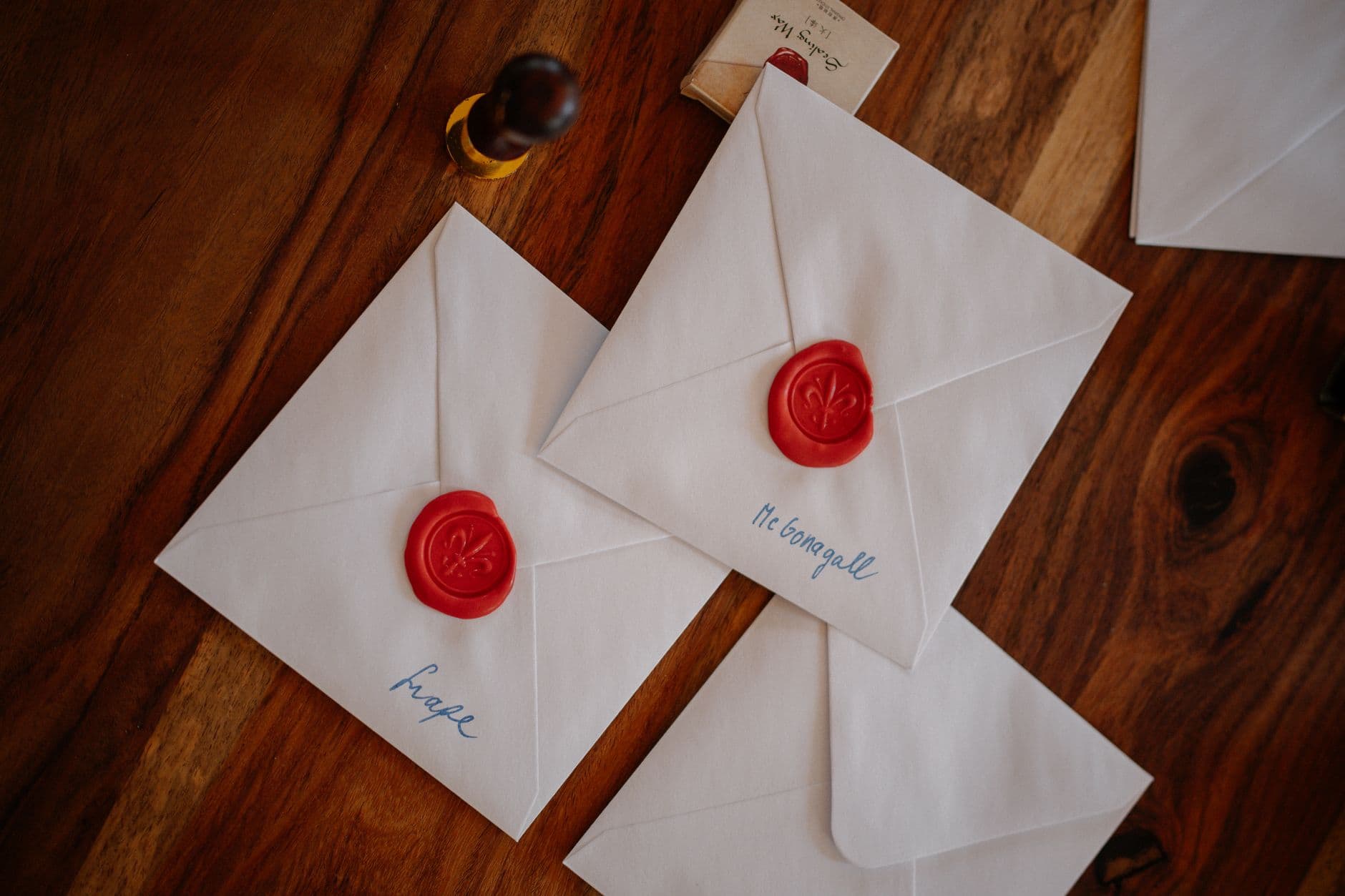 Birthday cards, envelopes and stamps laid out on a table