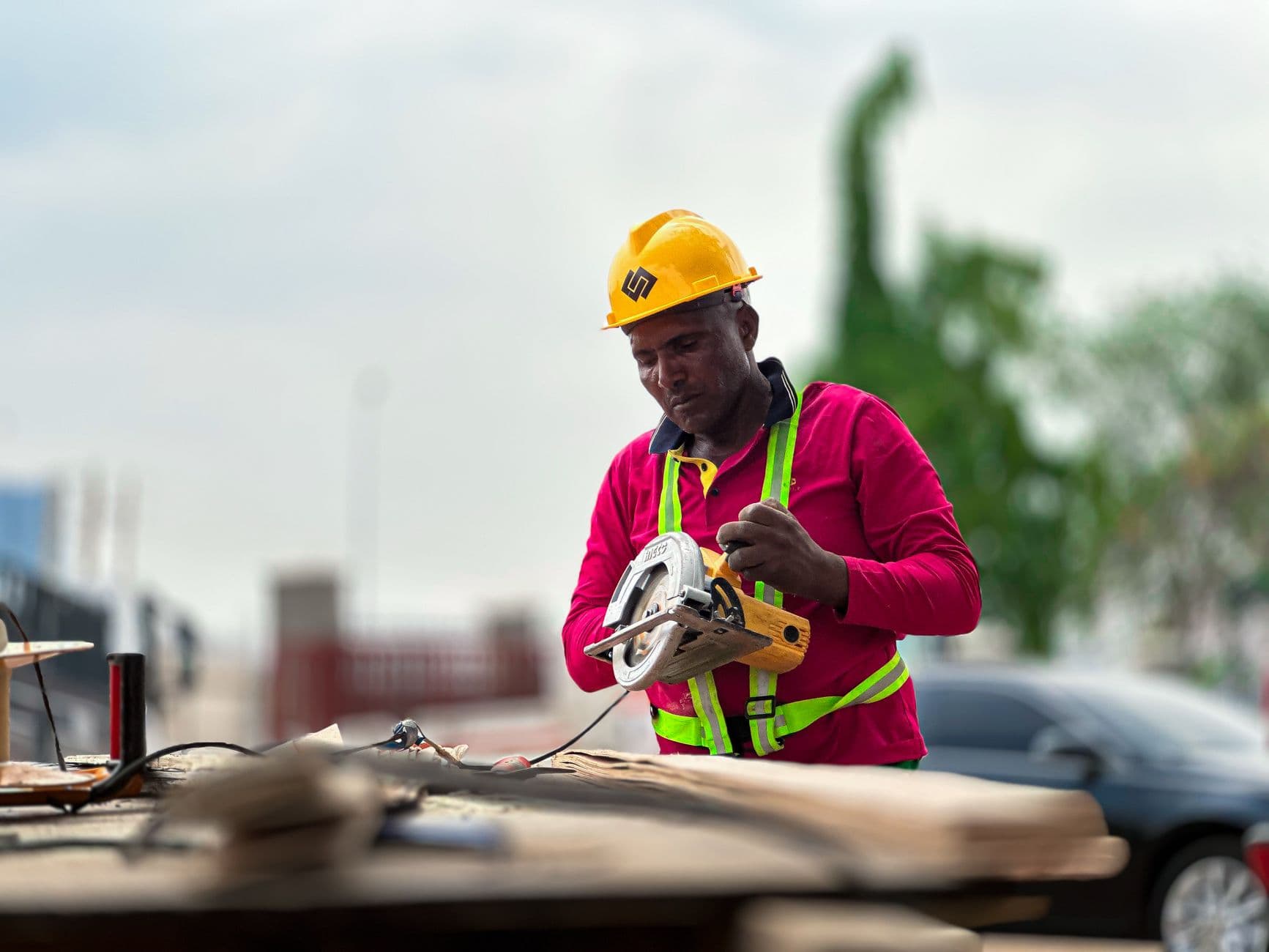 Someone photographing a piece of equipment with a phone on a work site