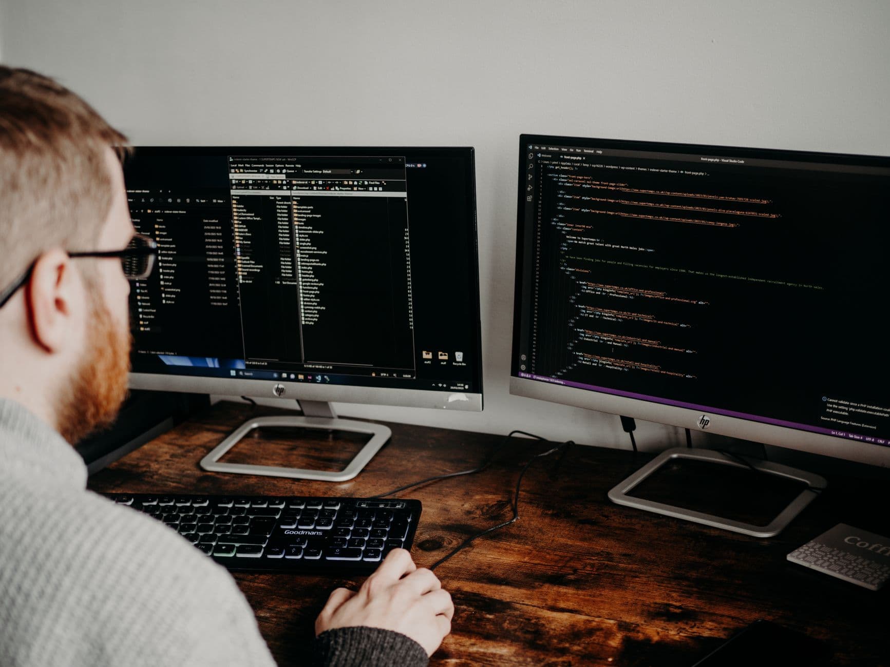 Software developers working together at desks with monitors