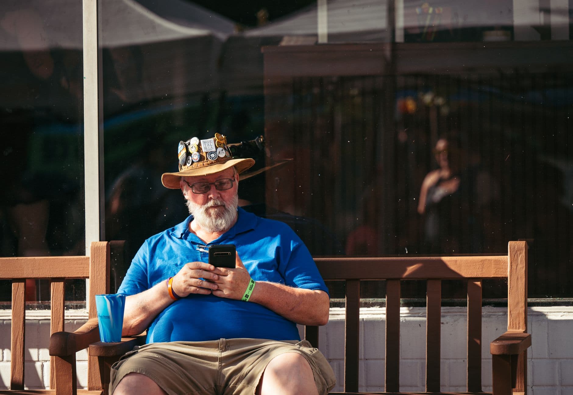 An older person using a smartphone with large on-screen text